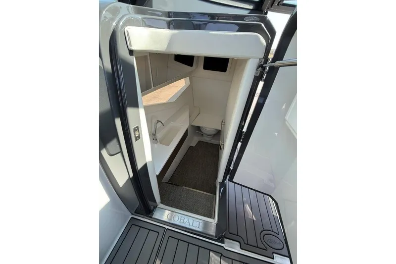 Slide: The Image of 2019 Cobalt A36 boat interior cabin with sink and carpeted floor. - 39
