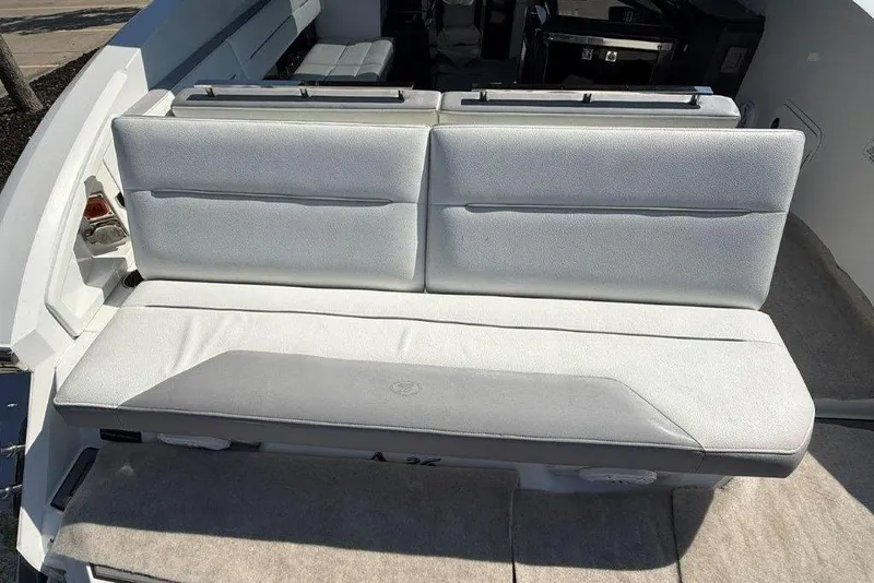 Slide: The Image of 2019 Cobalt A36 boat interior with white cushioned seating. - 47