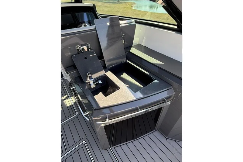 Slide: The Image of 2019 Cobalt A36 boat interior with open storage compartment and sleek design. - 50