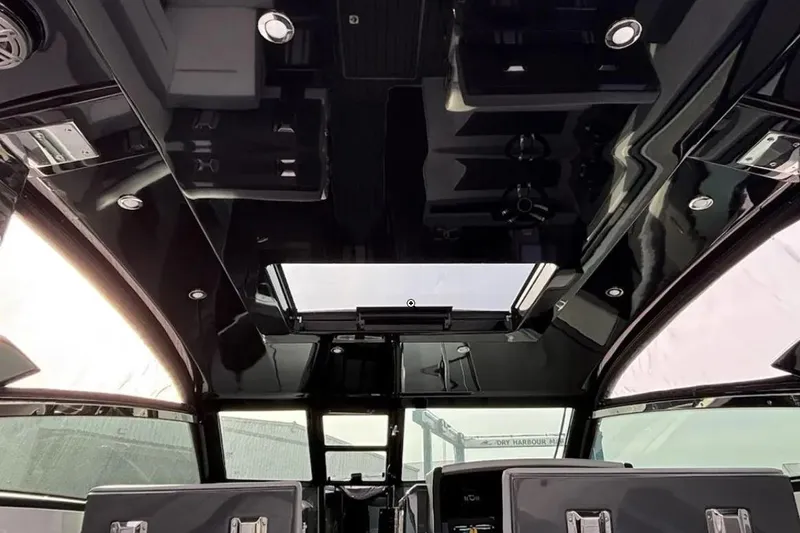 Slide: The Image of Interior view of a 2019 Cobalt A36 boat with sleek black ceiling design. - 7