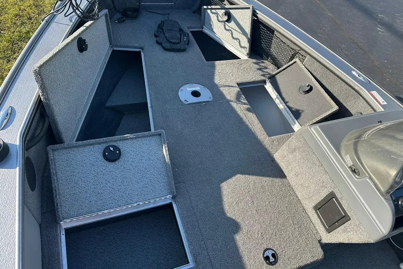 Slide: The Image of 2016 Lund 1775 Pro-V SS boat interior with open storage compartments. - 14