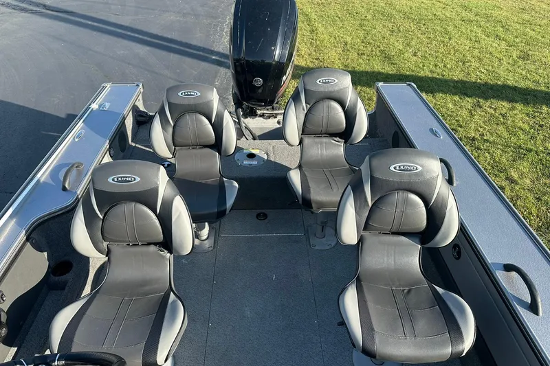 Slide: The Image of 2016 Lund 1775 Pro-V SS boat interior with four seats and motor. - 16