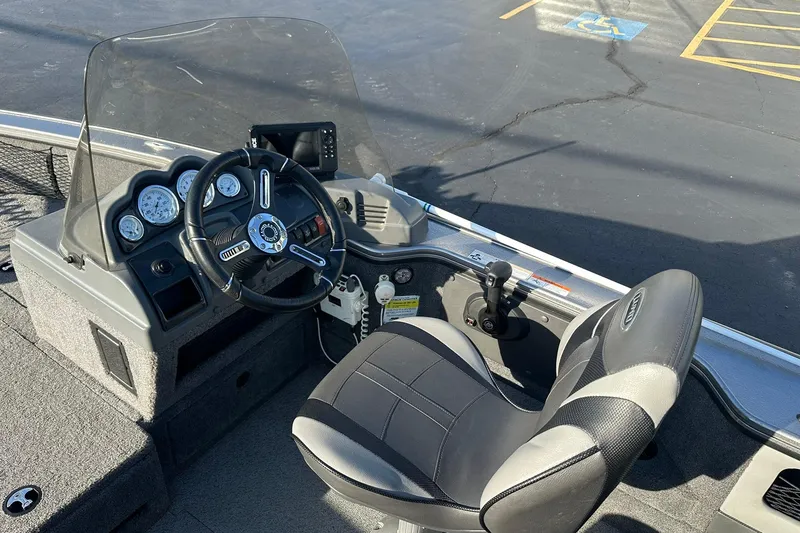 Slide: The Image of 2016 Lund 1775 Pro-V SS boat interior with steering wheel and dashboard controls. - 17