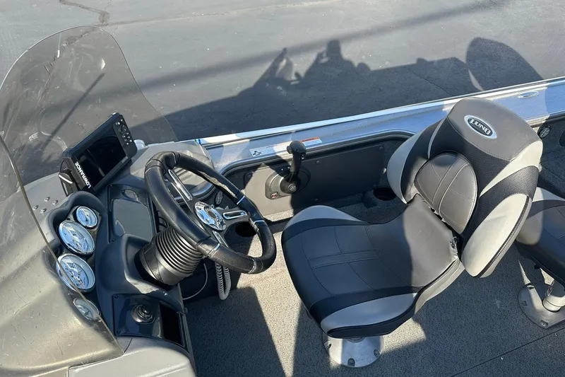 Slide: The Image of 2016 Lund 1775 Pro-V SS boat interior with steering wheel and seat. - 18