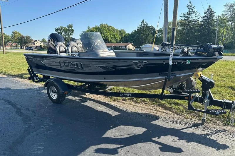 Slide: The Image of 2016 Lund 1775 Pro-V SS fishing boat on trailer, parked outdoors. - 3