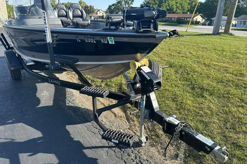 Slide: The Image of 2016 Lund 1775 Pro-V SS boat on trailer, parked on grass. - 4