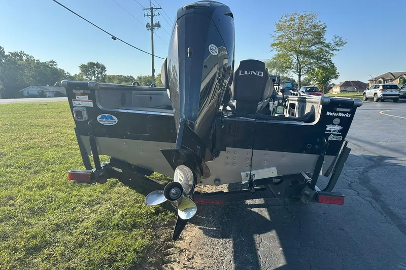Slide: The Image of 2016 Lund 1775 Pro-V SS boat with outboard motor, parked on grass. - 5