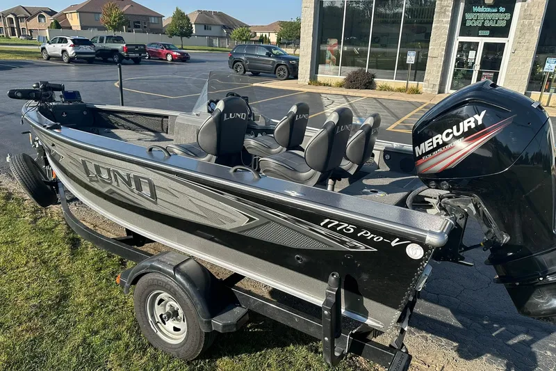 Slide: The Image of 2016 Lund 1775 Pro-V SS boat with Mercury engine on trailer, parked outside dealership. - 6