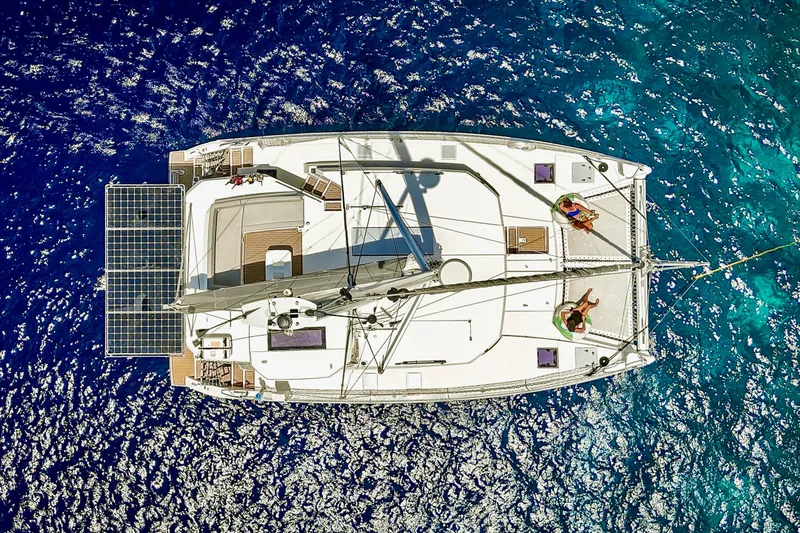 Slide: The Image of Aerial view of 2023 Leopard 42 catamaran sailing on vibrant blue ocean waters. - 10