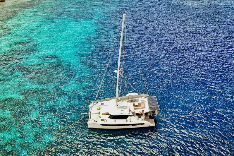 Slide: The Image of Aerial view of 2023 Leopard 42 catamaran sailing on vibrant blue ocean waters. - 100