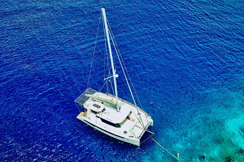 Slide: The Image of Aerial view of 2023 Leopard 42 catamaran sailing in vibrant blue ocean waters. - 101