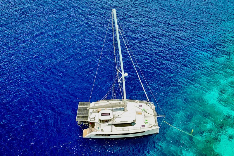 Slide: The Image of Aerial view of 2023 Leopard 42 catamaran sailing on vibrant blue ocean waters. - 102