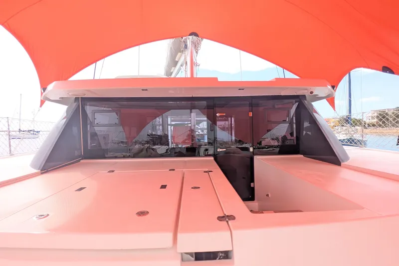 Slide: The Image of 2023 Leopard 42 yacht with orange canopy, docked at marina. - 16