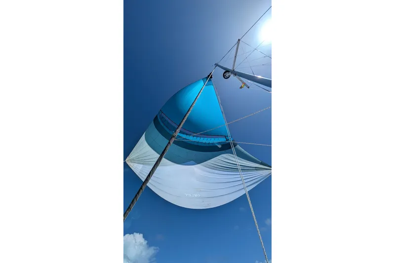 Slide: The Image of Sail of a 2023 Leopard 42 yacht against a clear blue sky. - 19