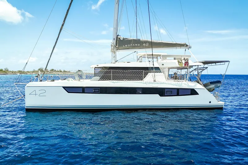 Slide: The Image of 2023 Leopard 42 catamaran sailing on clear blue ocean waters. - 2