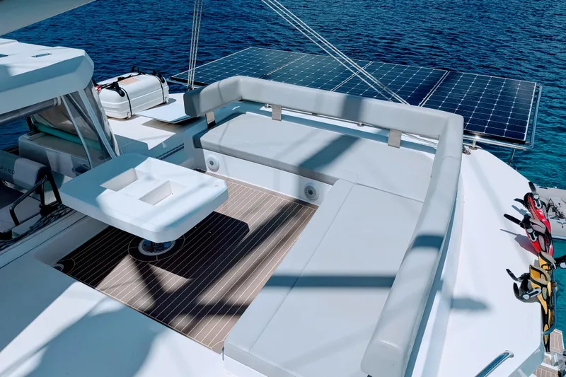 Slide: The Image of Luxurious Leopard 42 catamaran deck with solar panels, 2023 model, overlooking serene blue waters. - 21