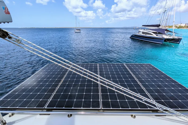 Slide: The Image of Leopard 42 catamaran with solar panels on deck, anchored in clear blue waters, 2023 model. - 22