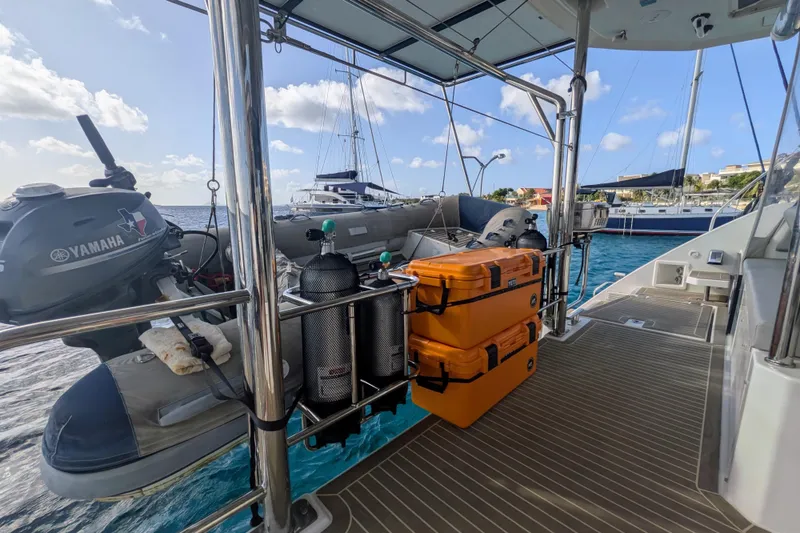 Slide: The Image of Leopard 42 catamaran deck with Yamaha motor, scuba tanks, and orange storage cases, 2023 model. - 31