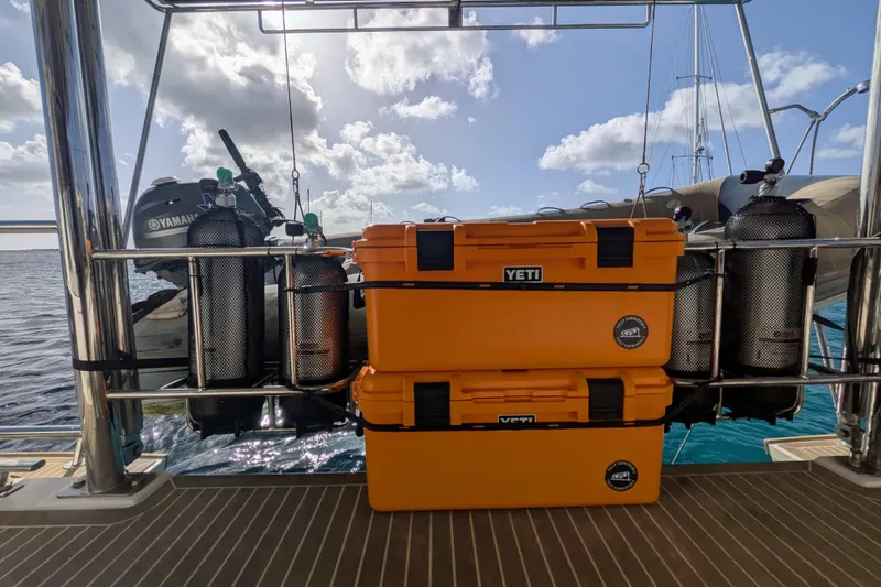 Slide: The Image of Orange YETI coolers and scuba tanks on a 2023 Leopard 42 yacht deck. - 32