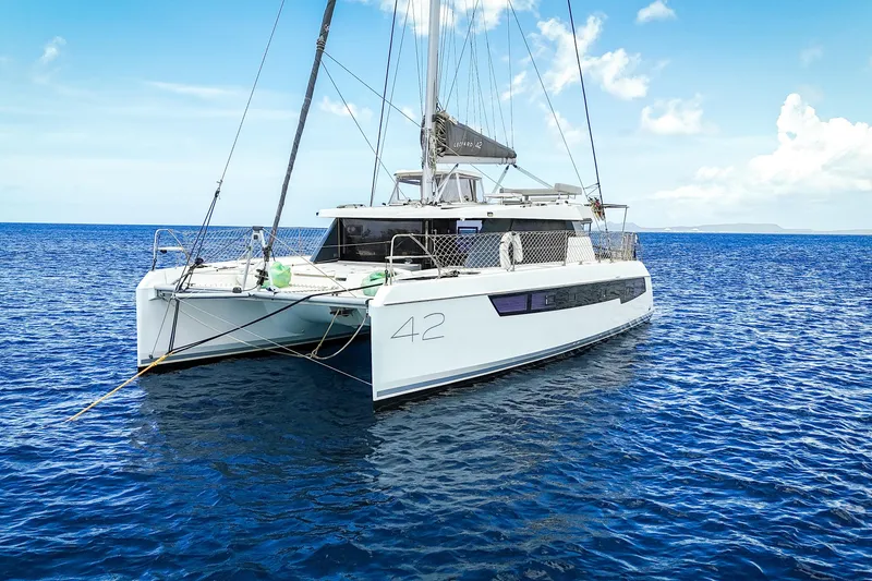 Slide: The Image of 2023 Leopard 42 catamaran sailing on clear blue ocean under a sunny sky. - 5