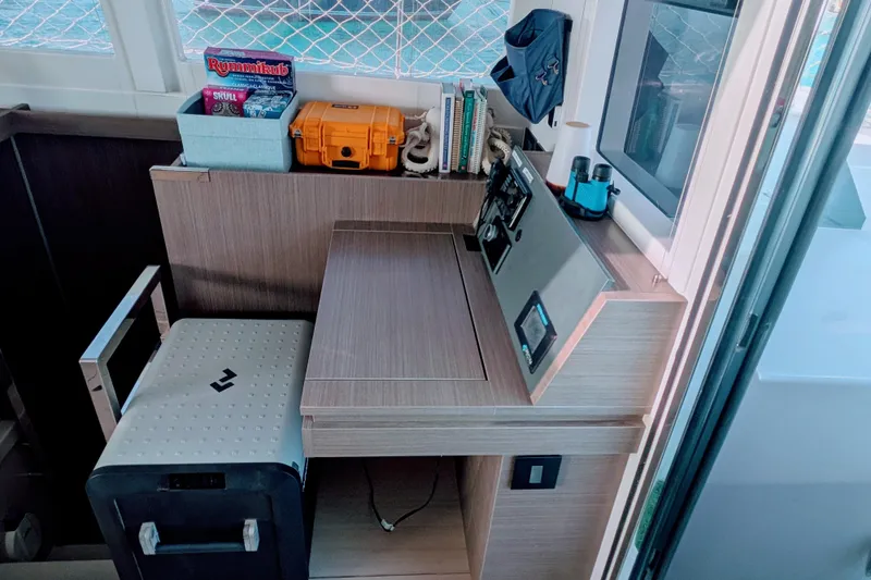 Slide: The Image of Navigation station on a 2023 Leopard 42 yacht with books and equipment. - 52