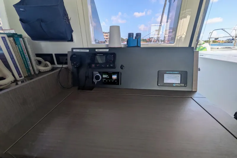 Slide: The Image of 2023 Leopard 42 yacht navigation station with communication equipment and books. - 54