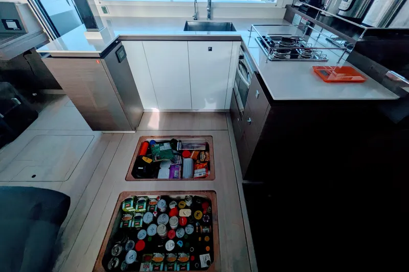 Slide: The Image of Modern Leopard 42 yacht kitchen with hidden floor storage, stove, and sleek cabinetry, 2023 model. - 59