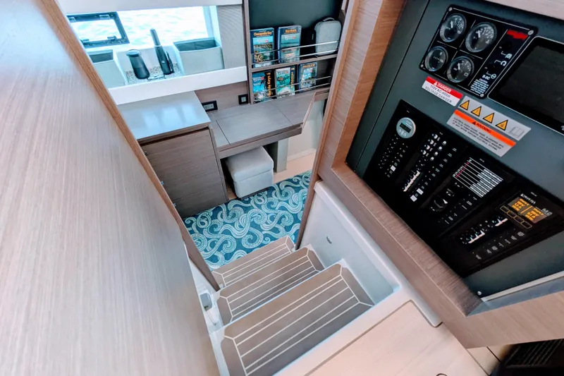 Slide: The Image of Modern Leopard 42 yacht interior with control panel, desk, and patterned carpet, 2023 model. - 64
