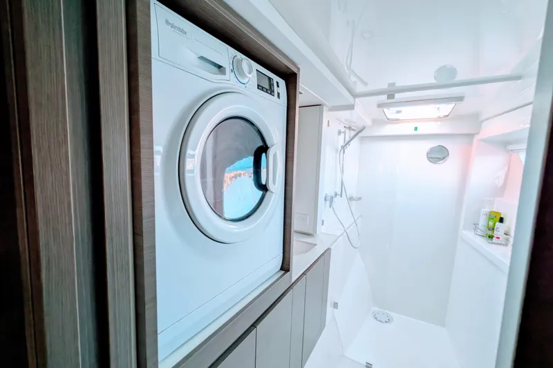 Slide: The Image of Laundry area and shower in 2023 Leopard 42 yacht, featuring modern appliances and sleek design. - 70