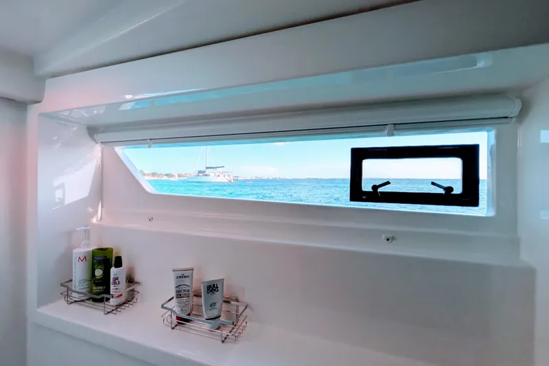Slide: The Image of Interior view of 2023 Leopard 42 yacht bathroom with ocean view through window. - 73