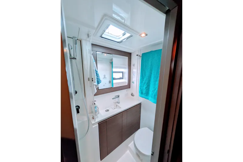 Slide: The Image of Modern bathroom in 2023 Leopard 42 yacht with shower, sink, and teal towel. - 80