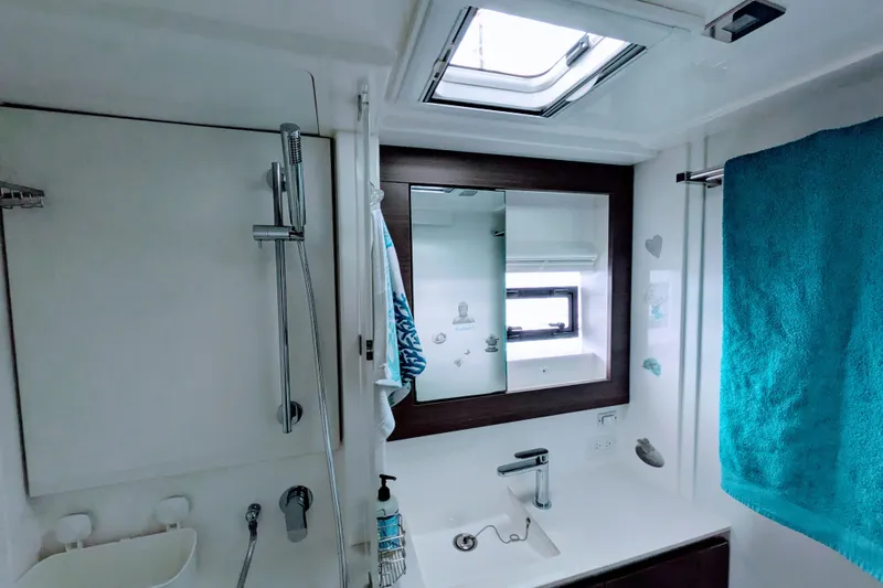 Slide: The Image of Modern bathroom in 2023 Leopard 42 yacht with shower, sink, and teal towel. - 82