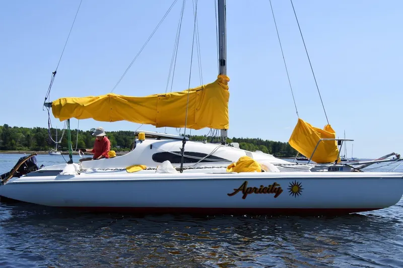 Slide: The Image of Sailboat Corsair F-24 MKII #299, 1999 model, with yellow sail covers on a sunny day. - 1