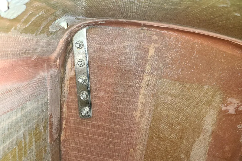 Slide: The Image of Interior view of 1999 Corsair F-24 MKII #293 showing fiberglass and metal bracket. - 11