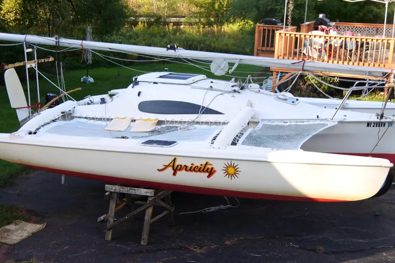 Slide: The Image of Corsair F-24 MKII #299 sailboat from 1999, named "Apricity," on a stand outdoors. - 2