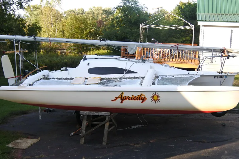 Slide: The Image of 1999 Corsair F-24 MKII sailboat named "Apricity" on a trailer in a backyard setting. - 3