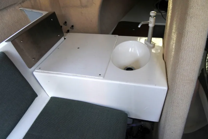 Slide: The Image of Interior of 1999 Corsair F-24 MKII sailboat with compact sink and seating area. - 4