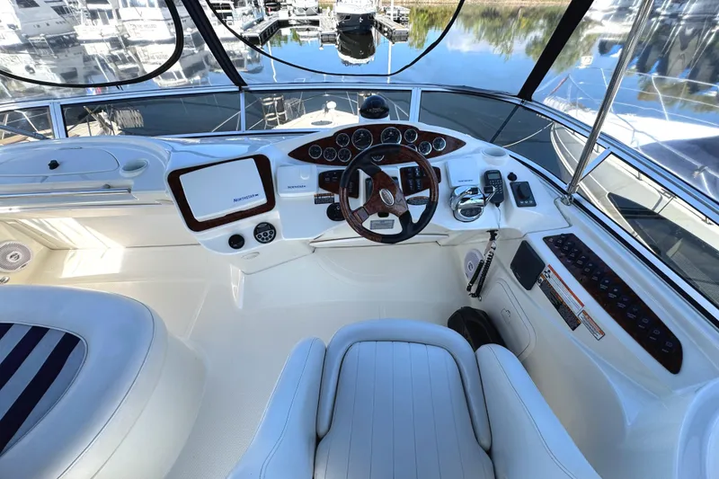 Slide: The Image of 2008 Meridian 391 Sedan helm with modern controls and luxurious seating at a marina. - 14