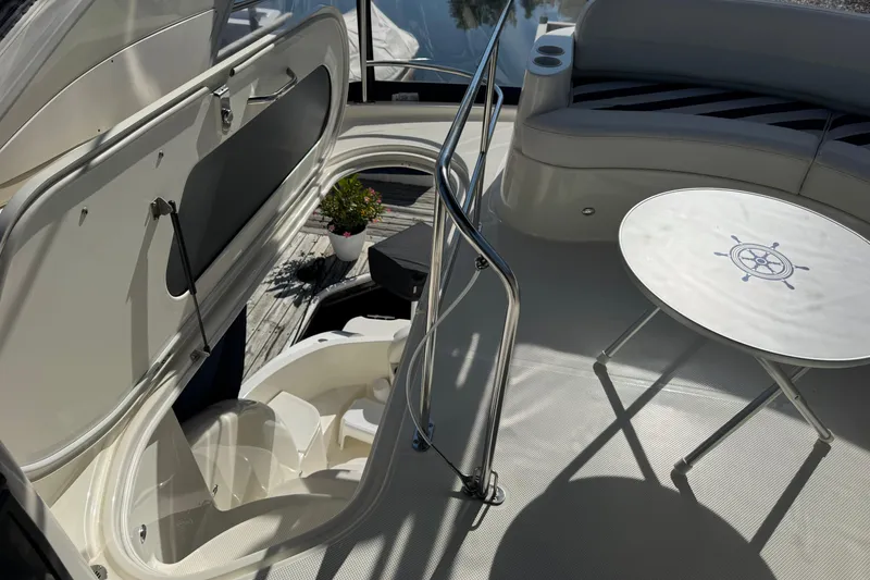 Slide: The Image of 2008 Meridian 391 Sedan yacht interior with seating, table, and open hatch. - 19