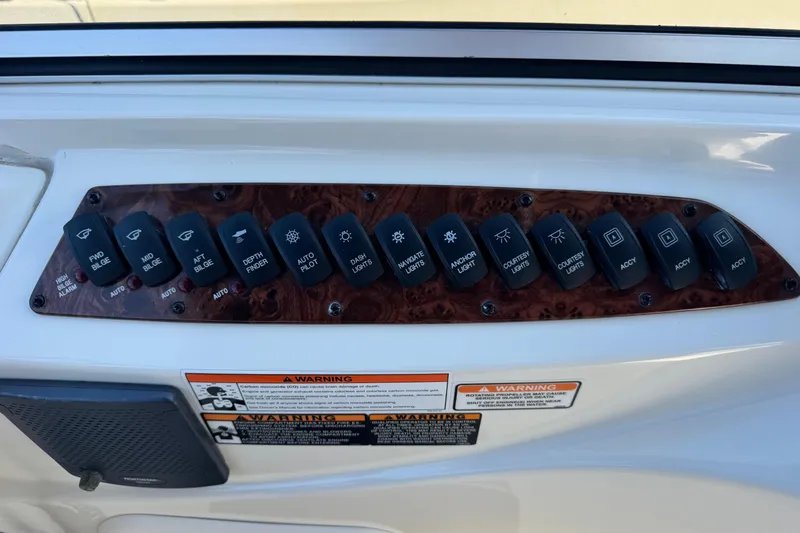 Slide: The Image of Control panel of a 2008 Meridian 391 Sedan boat with labeled switches. - 25