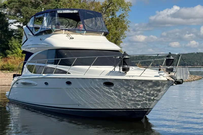 Slide: The Image of 2008 Meridian 391 Sedan yacht on calm water, surrounded by scenic nature. - 3