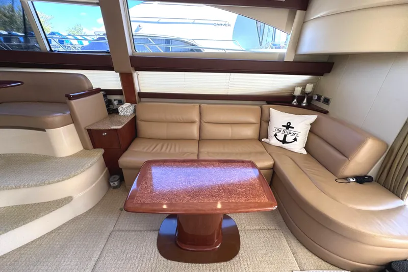 Slide: The Image of Luxurious interior of 2008 Meridian 391 Sedan yacht with beige leather seating and wooden table. - 30