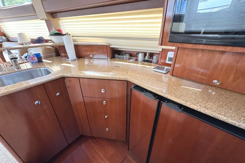 Slide: The Image of Luxurious kitchen interior of 2008 Meridian 391 Sedan yacht with wood cabinetry and granite countertops. - 33