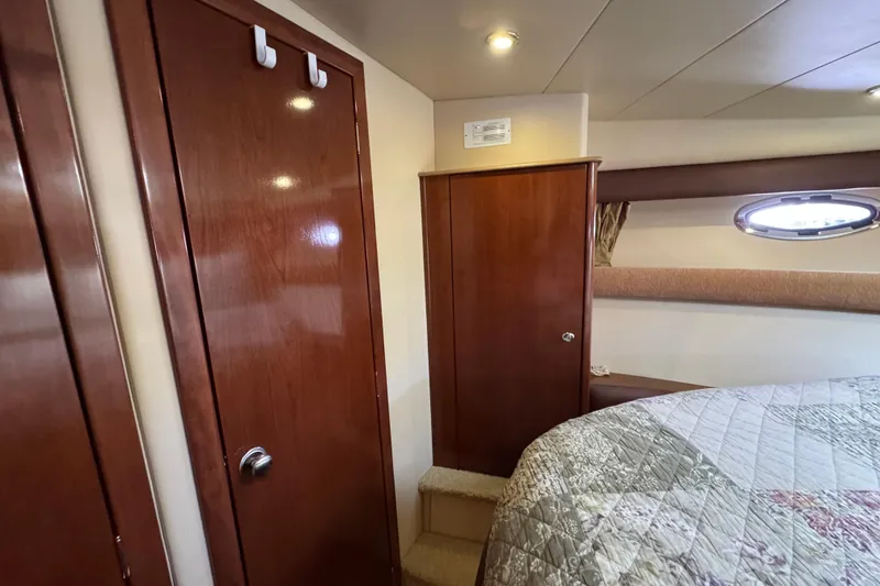 Slide: The Image of Interior of 2008 Meridian 391 Sedan yacht with wooden cabinets and cozy bedding. - 40