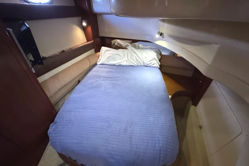 Slide: The Image of Cozy bedroom in 2008 Meridian 391 Sedan yacht with blue bedding and ambient lighting. - 45