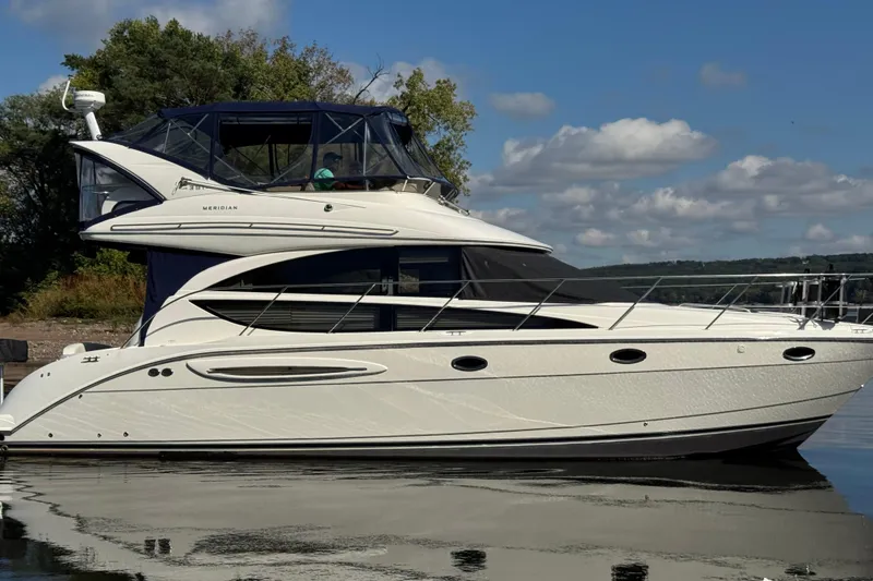 Slide: The Image of 2008 Meridian 391 Sedan yacht on calm water under a blue sky. - 5