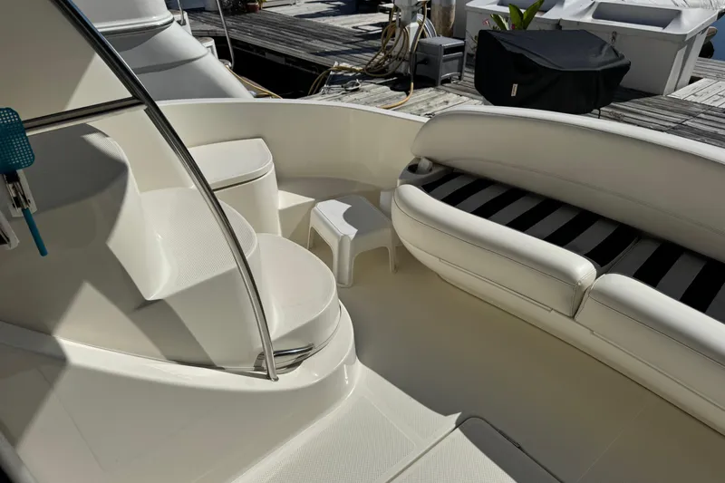 Slide: The Image of 2008 Meridian 391 Sedan yacht interior with white seating and steps, docked at marina. - 7