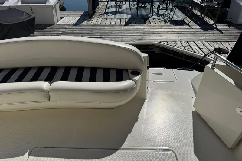 Slide: The Image of 2008 Meridian 391 Sedan boat interior with white seating and dock view. - 8