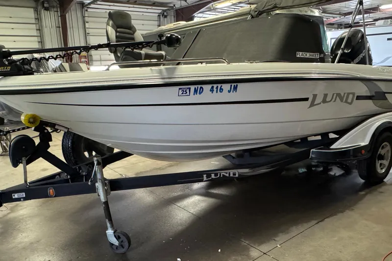 Slide: The Image of 2009 Lund 186 Tyee GL boat on trailer in a garage setting. - 1