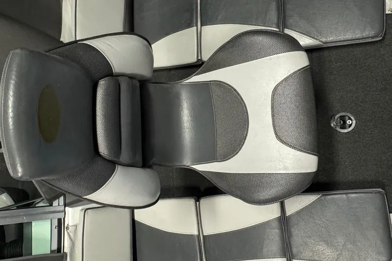 Slide: The Image of 2009 Lund 186 Tyee GL boat seat, gray and white upholstery, top view. - 11